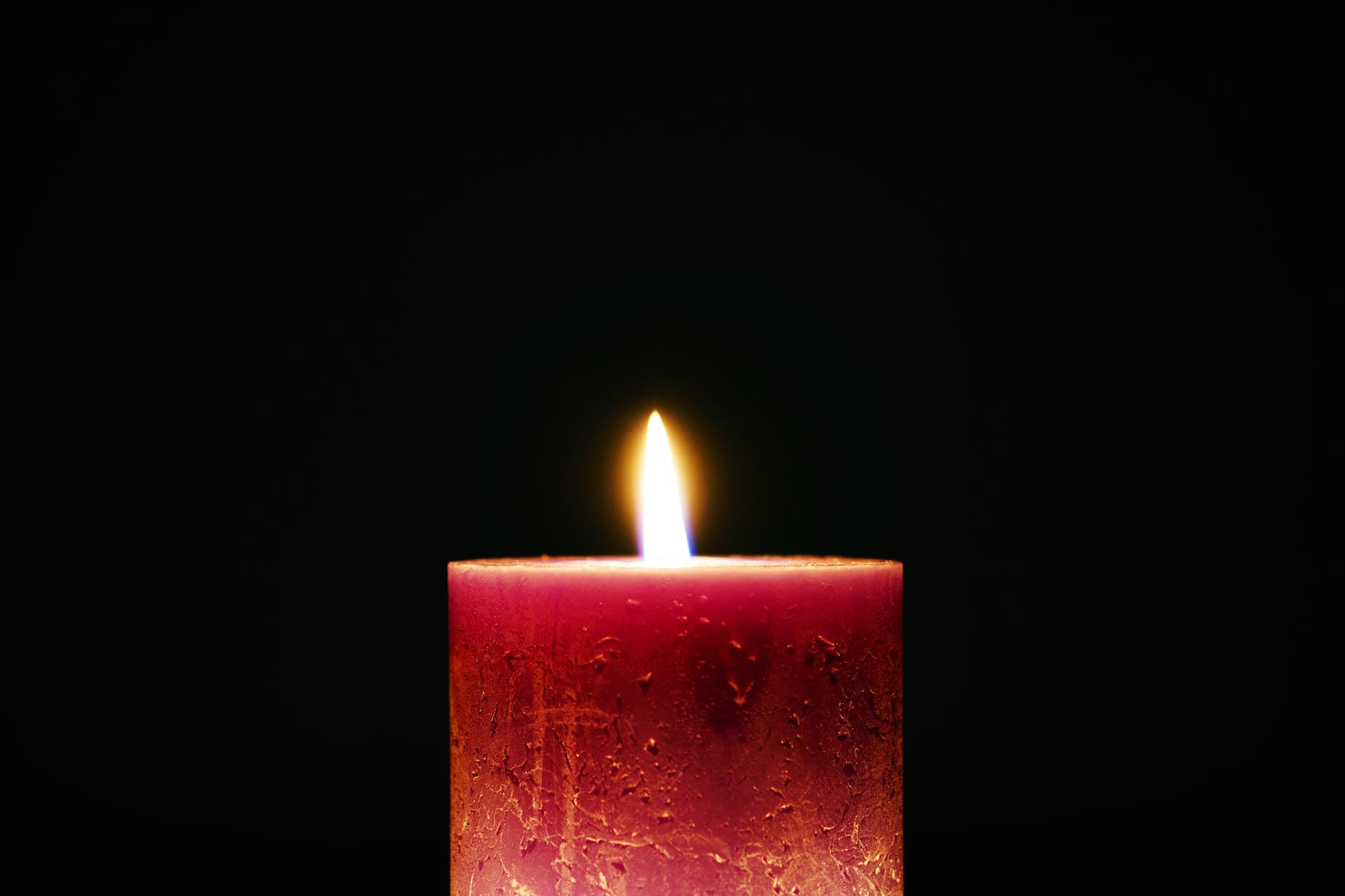 Red candle, white flame, black background--signifying our dreams

